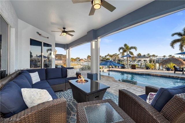 view of patio with outdoor lounge area, a fenced in pool, and ceiling fan