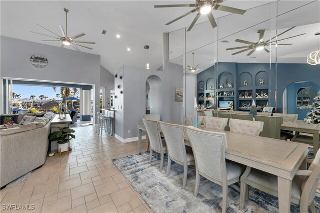 dining space featuring high vaulted ceiling