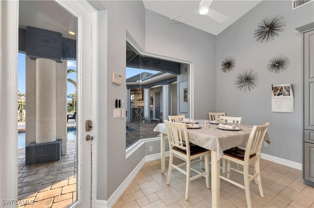 tiled dining area with ceiling fan