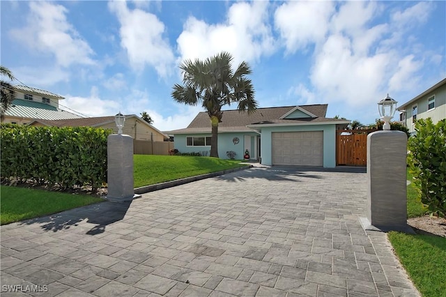 view of front of property with a garage and a front lawn