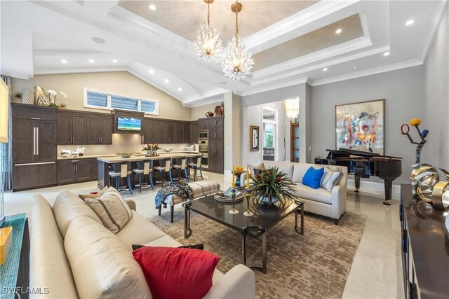 living room with lofted ceiling, a tray ceiling, an inviting chandelier, and crown molding