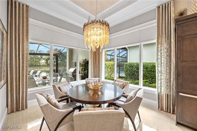 tiled dining space featuring a raised ceiling, crown molding, a water view, and a notable chandelier