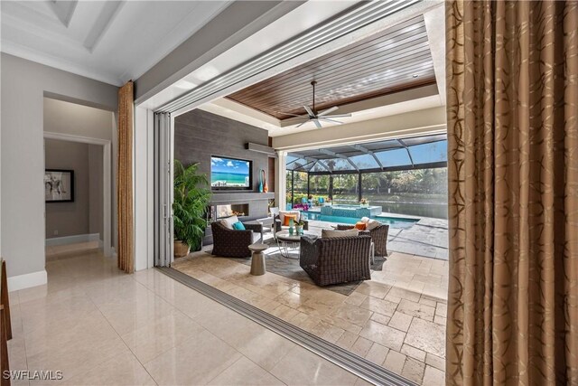 view of patio with glass enclosure, an outdoor living space, and ceiling fan