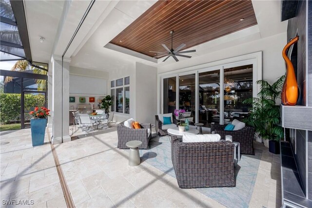 view of patio featuring outdoor lounge area, ceiling fan, and a lanai