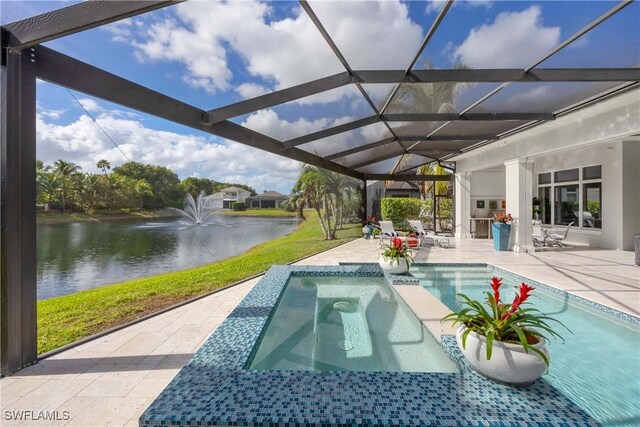 view of swimming pool with an in ground hot tub, a patio, a water view, and glass enclosure