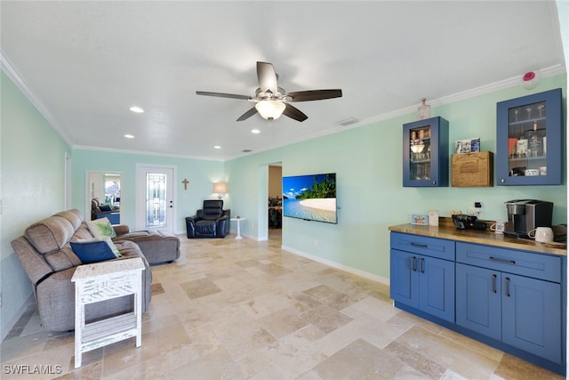 living room with ceiling fan and crown molding