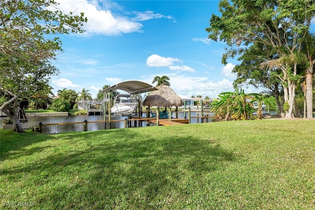 view of yard featuring a dock and a water view