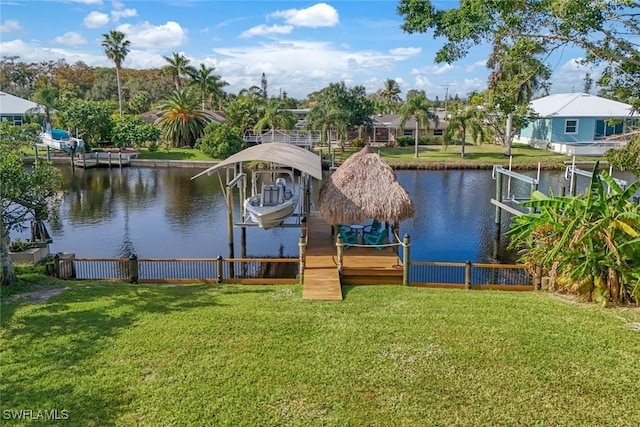 view of dock with a water view and a lawn