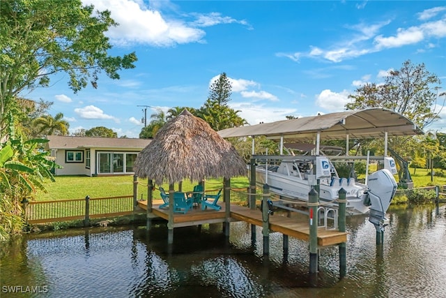 view of dock with a yard and a water view