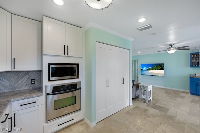 kitchen with decorative backsplash, ceiling fan, white cabinetry, and appliances with stainless steel finishes