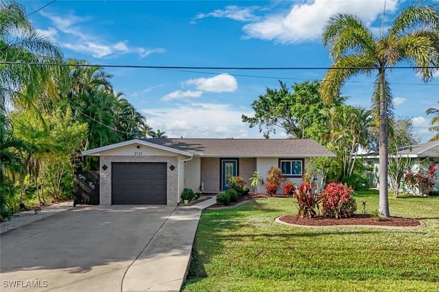 ranch-style house featuring a garage and a front yard