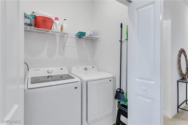 laundry area with washing machine and clothes dryer