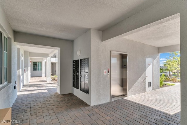 interior space with mail boxes and elevator