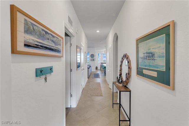 hall featuring light tile patterned floors