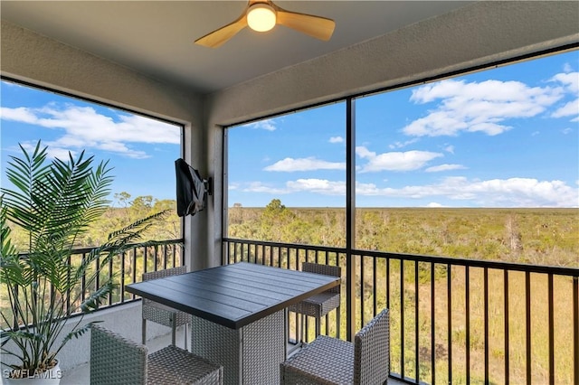 unfurnished sunroom with ceiling fan