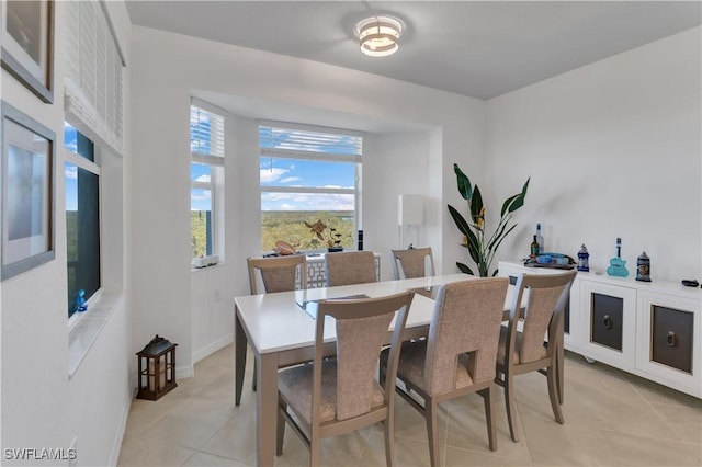 dining space featuring light tile patterned floors