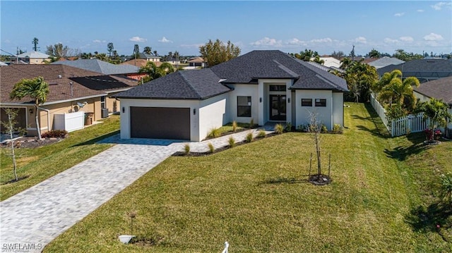 view of front of house with a front yard and a garage