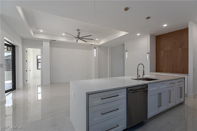 kitchen featuring ceiling fan, dishwasher, sink, pendant lighting, and a kitchen island with sink