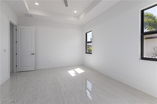 empty room featuring a raised ceiling