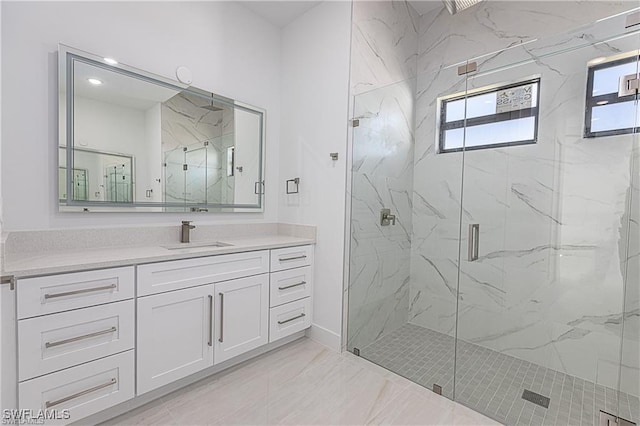 bathroom featuring vanity and a shower with door