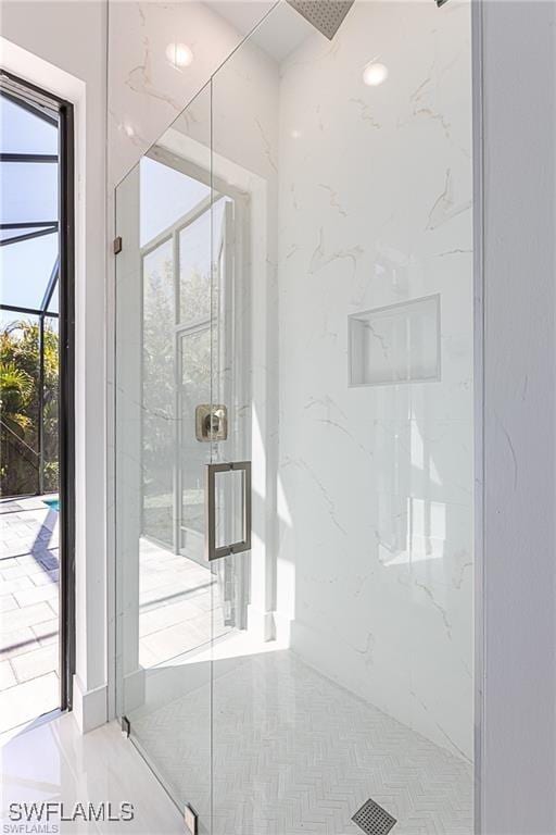 bathroom with a shower with shower door