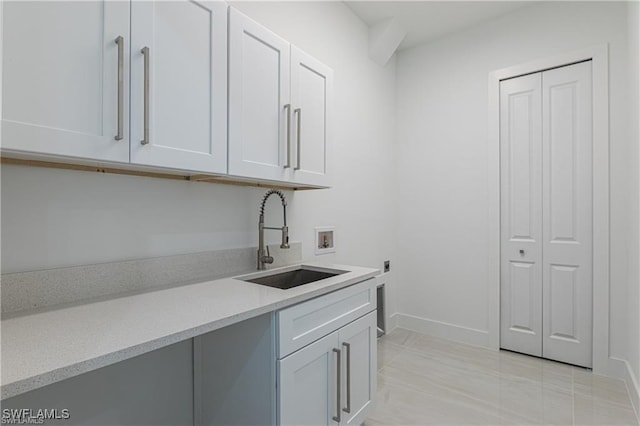 interior space featuring white cabinetry, sink, and light tile patterned flooring