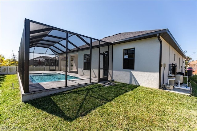 back of house with a patio area, a lanai, and a lawn