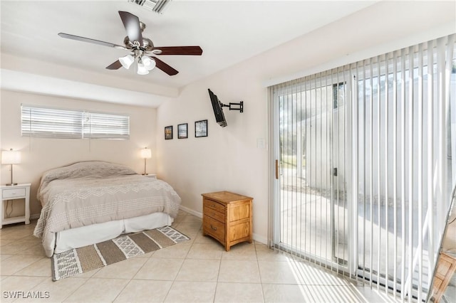 tiled bedroom featuring multiple windows, access to exterior, and ceiling fan