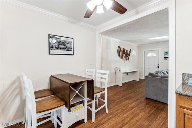 dining room featuring crown molding, dark wood-type flooring, and ceiling fan