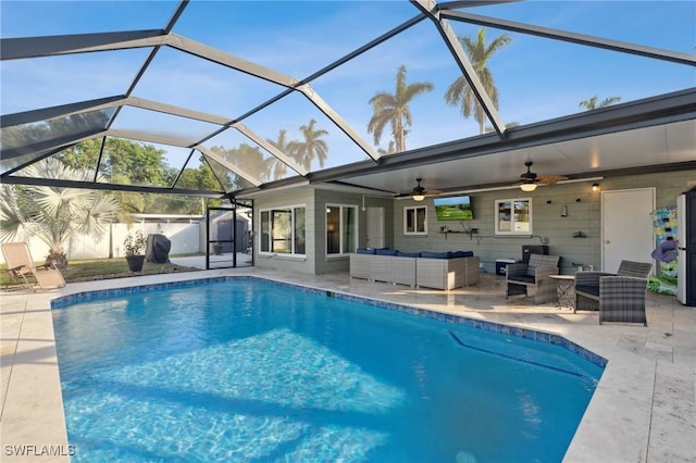 view of swimming pool featuring ceiling fan, an outdoor hangout area, a patio, and a lanai