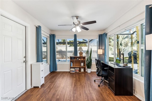 home office with dark hardwood / wood-style floors and ceiling fan