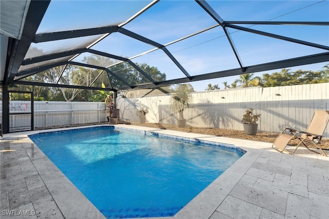 view of swimming pool with a lanai and a patio