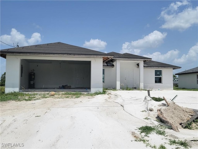 view of front of house featuring a garage and electric water heater