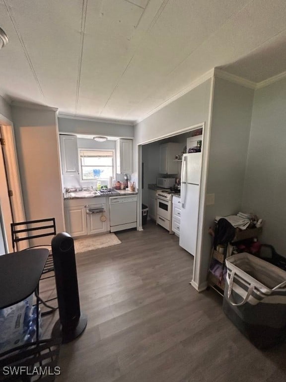 kitchen with white cabinets, dark hardwood / wood-style flooring, white appliances, and ornamental molding