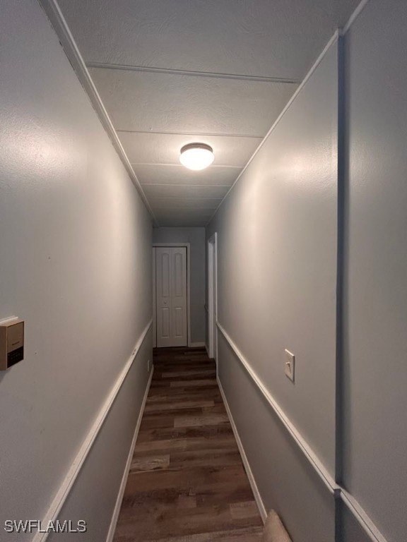 hallway with dark hardwood / wood-style flooring