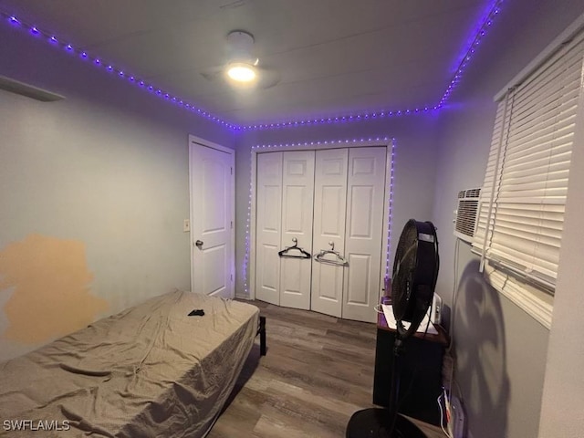 bedroom with hardwood / wood-style floors and a closet