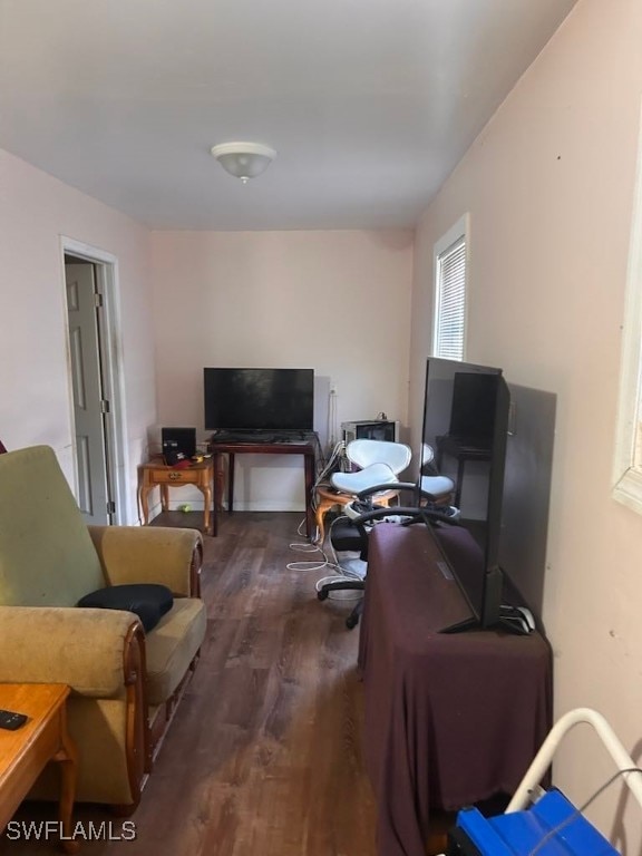 home office with dark hardwood / wood-style flooring