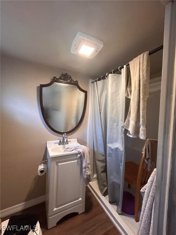 bathroom featuring hardwood / wood-style floors, vanity, and a shower with shower curtain