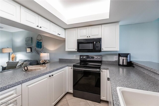 kitchen featuring black appliances, white cabinets, and light tile patterned floors