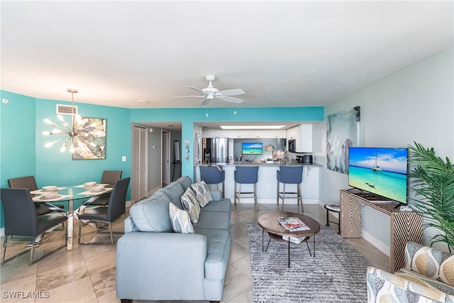 living room featuring ceiling fan with notable chandelier