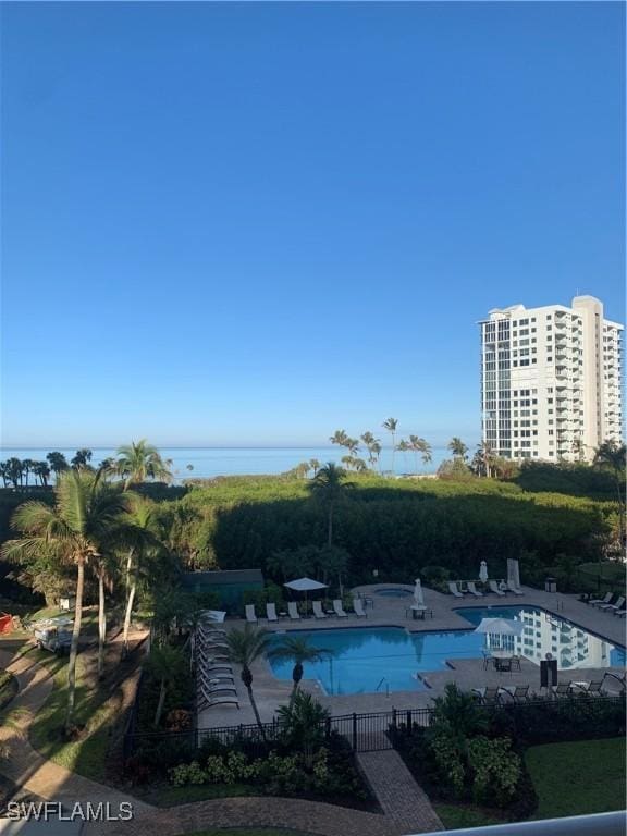 view of pool featuring a patio area and a water view