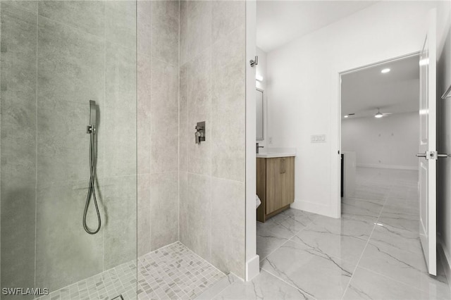 bathroom with vanity and a tile shower