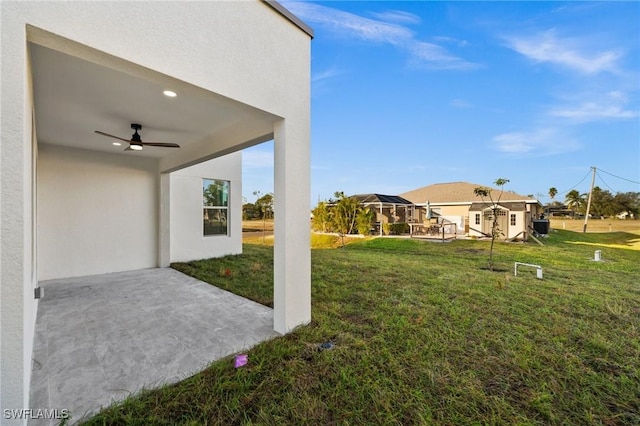 view of yard featuring a patio and ceiling fan