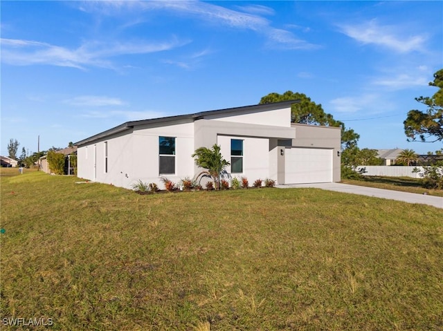 view of front of home with a front yard and a garage