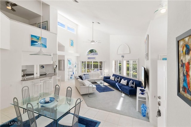 living room with light tile patterned flooring and high vaulted ceiling