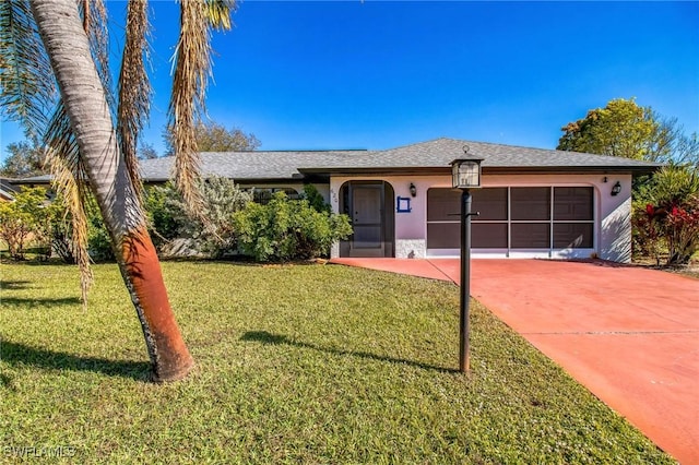 single story home featuring a garage and a front yard