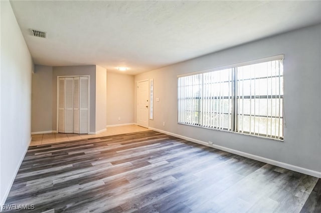 empty room with dark hardwood / wood-style floors