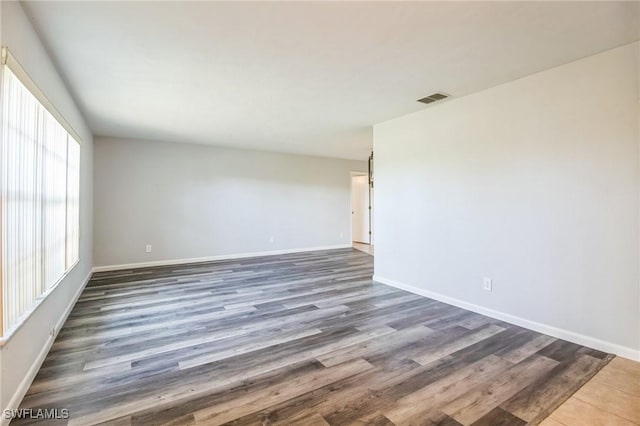 unfurnished room with dark hardwood / wood-style floors