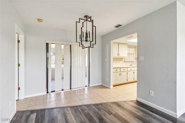 unfurnished dining area featuring light hardwood / wood-style flooring