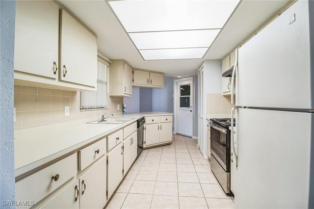 kitchen featuring appliances with stainless steel finishes, backsplash, extractor fan, sink, and light tile patterned floors